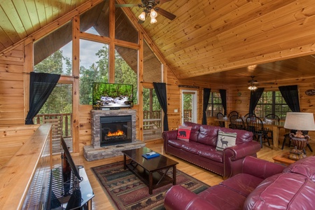 Living room with a fireplace and TV Kick Back & Relax! A 4 bedroom cabin rental located in Pigeon Forge