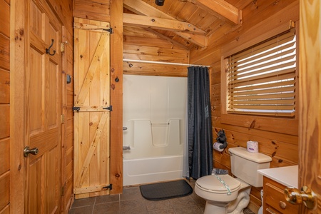 Tub and shower in a bathroom at Livin' Simple, a 2 bedroom cabin rental located in Pigeon Forge