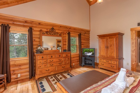 Bedroom with a dresser and mirror, armoire, and television at I Do Love Views, a 3 bedroom cabin rental located in Pigeon Forge
