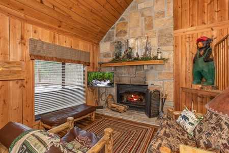 Living room with fireplace, TV, and seating at Papa Bear, a 3 bedroom cabin rental located in Pigeon Forge