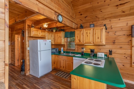 kitchen with white appliances at angel's majestic view a 3 bedroom cabin rental located in pigeon forge