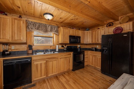 Kitchen with black appliances at Bears Don't Bluff, a 3 bedroom cabin rental located in Pigeon Forge
