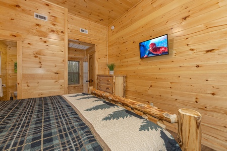 Dresser and TV in a bedroom at Poolin Around, a 2 bedroom cabin rental located in Gatlinburg