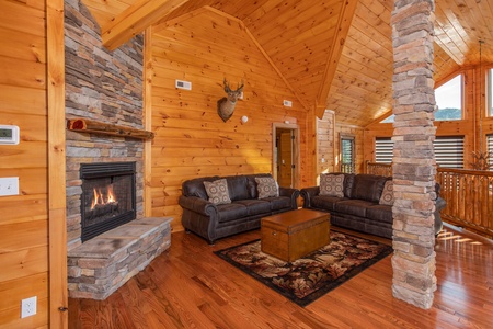 Upper living room with a fireplace and plenty of seating at Four Seasons Palace, a 5-bedroom cabin rental located in Pigeon Forge