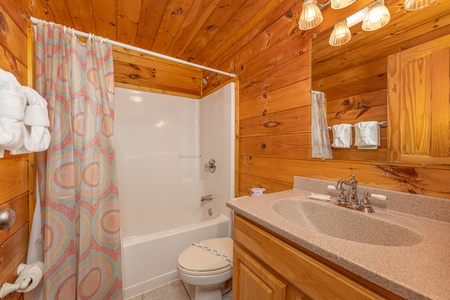 Bathroom with a tub and shower at Family Getaway, a 4 bedroom cabin rental located in Pigeon Forge