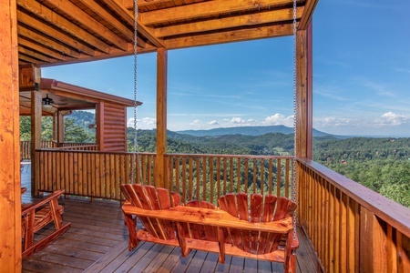 Adirondack style porch swing overlooking the views at Four Seasons Palace, a 5-bedroom cabin rental located in Pigeon Forge