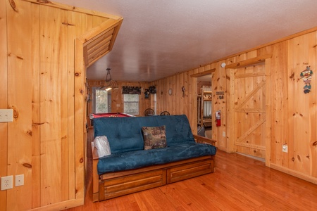 Sleeper sofa in the game room at Bearly in the Mountains, a 5-bedroom cabin rental located in Pigeon Forge