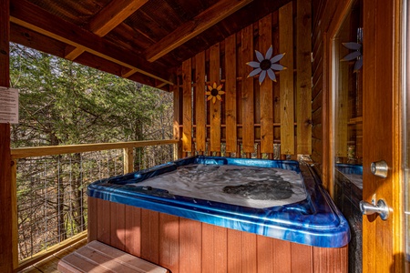 Hot tub on covered deck at Bear Feet Retreat, a 1 bedroom cabin rental located in pigeon forge