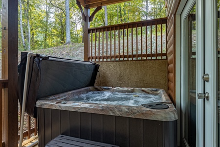 Hot tub on a covered deck at Gar Bear's Hideaway, a Pigeon Forge cabin rental