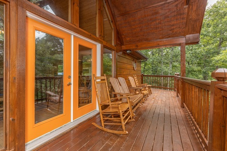 Rocking chairs on the deck at Wildlife Retreat, a 3 bedroom cabin rental located in Pigeon Forge