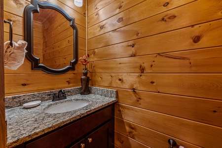 Bathroom sink and mirror at Four Seasons Grand, a 5 bedroom cabin rental located in Pigeon Forge