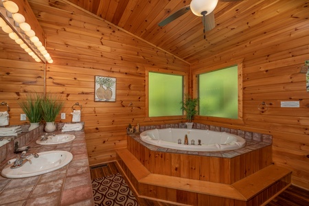 Jacuzzi tub and two sinks in the main bedroom at Hawk's Heart Lodge, a 3 bedroom cabin rental located in Pigeon Forge