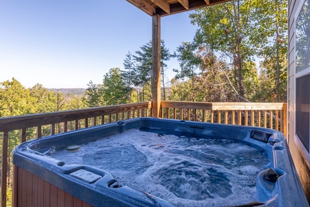 Hot tub on a covered deck at Le Bear Chalet, a 7 bedroom cabin rental located in Gatlinburg
