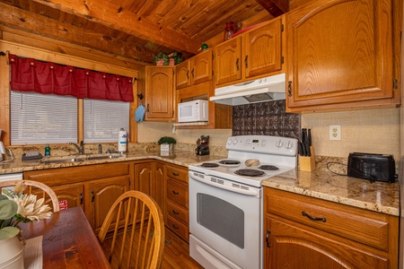 kitchen stove at Little Bear, a 1 bedroom cabin rental located in Pigeon Forge