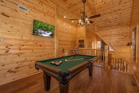 Pool table and TV in the loft at Pinot Splash, a 4 bedroom cabin rental located in Gatlinburg