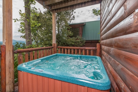 Hot tub on a covered deck at A Beautiful Memory, a 4 bedroom cabin rental located in Pigeon Forge