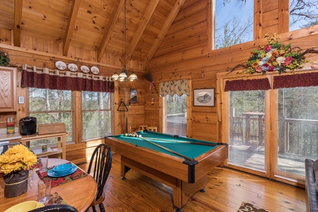 Pool table in the great room with deck access at Cloud 9, a 1-bedroom cabin rental located in Pigeon Forge