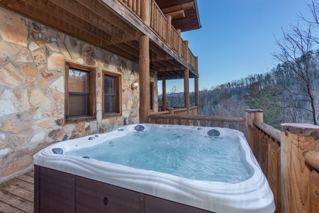 Hot tub with mountain views on an open deck at Great View Lodge, a 5-bedroom cabin rental located in Pigeon Forge