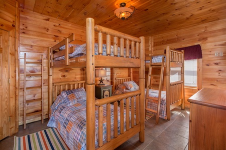 Bedroom with four bunk beds at Ella-Vation, a 3 bedroom cabin rental located in Gatlinburg