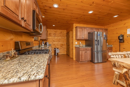 Kitchen with stainless appliances and granite counters at J's Hideaway, a 4 bedroom cabin rental located in Pigeon Forge