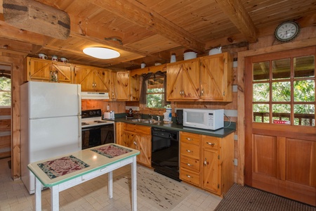 Kitchen with black and white appliances at Mountain Glory, a 1 bedroom cabin rental located in Pigeon Forge