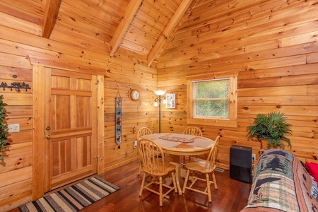 Dining space with seating for four at Enchanted Evening, a 1-bedroom cabin rental located in Pigeon Forge