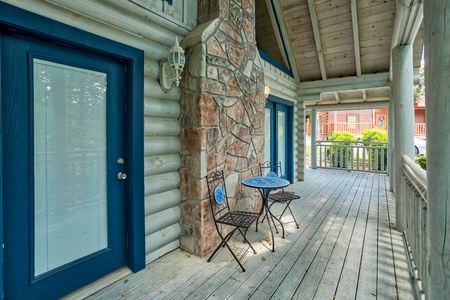 bistro seating on a covered deck at alpine something blue a 1 bedroom cabin rental located in pigeon forge