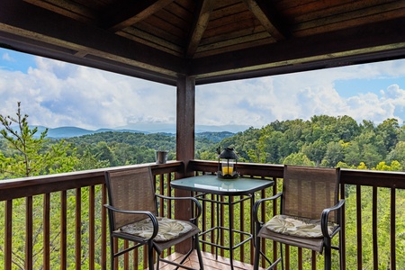 Deck table and chairs for two at Eagle's Nest, a 2-bedroom cabin rental located in Sevierville