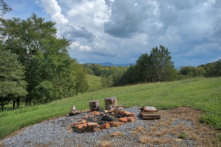 Fire pit in the yard at Cedar Creeks, a 2-bedroom cabin rental located near Douglas Lake