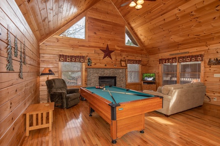 Pool table in the living room at Bearly Mine, a 1 bedroom Pigeon Forge cabin rental