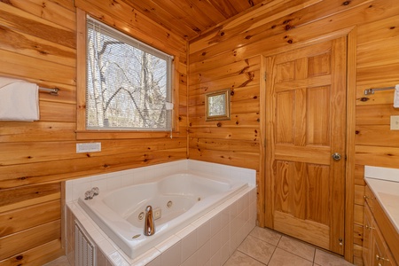 Bathroom with a jacuzzi at Hickernut Lodge, a 5-bedroom cabin rental located in Pigeon Forge