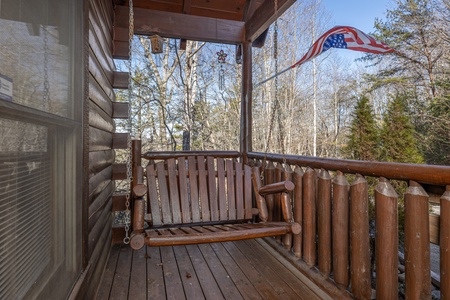 Swing on the front porch at Nascar Nation, a 2 bedroom cabin rental located in Pigeon Forge