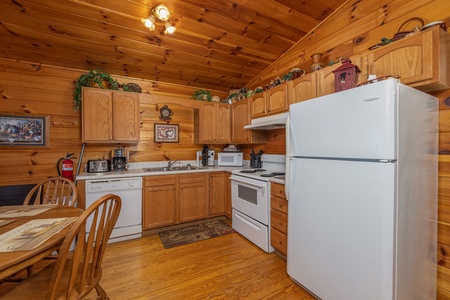 Kitchen with white appliances at A Cheerful Heart, a 2 bedroom cabin rental located in Pigeon Forge
