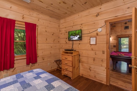 Dresser and TV in a bedroom at Patriot Pointe, a 5 bedroom cabin rental located in Pigeon Forge