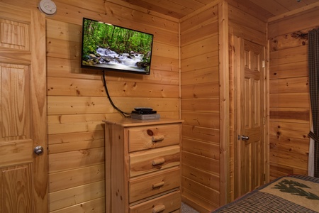 Dresser and TV in a bedroom at Kick Back & Relax! A 4 bedroom cabin rental located in Pigeon Forge