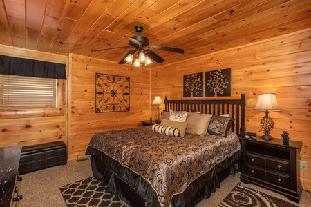 King bed and two night stands in a bedroom at Better View, a 4 bedroom cabin rental located in Pigeon Forge