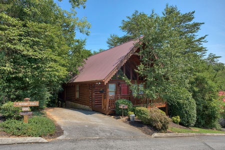 exterior of cabin with paved parking at alpine sunset thrill a 1 bedroom cabin rental located in pigeon forge