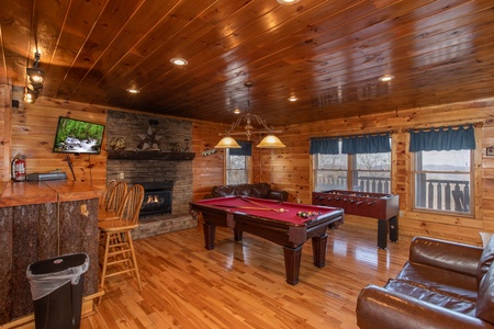 Fireplace, bar, and TV in the game room at 5 Star View, a 3 bedroom cabin rental located in Gatlinburg