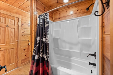 Bathroom with a tub and shower at Honey Bear Haven, a 1 bedroom cabin rental located in Pigeon Forge