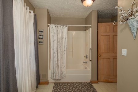 Bathroom with a tub and shower at Bearadise 4 Us, a 3 bedroom cabin rental located in Pigeon Forge