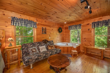 Futon and jacuzzi in the king bedroomat Misty Mountain Escape, a 2 bedroom cabin rental located in Gatlinburg