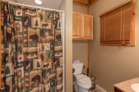 Bathroom with a tub and shower off the game room at Great View Lodge, a 5-bedroom cabin rental located in Pigeon Forge
