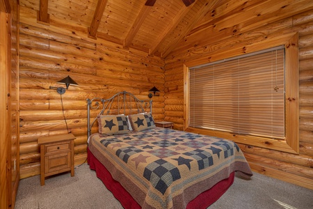 Bedroom with two night stands at Gone Fishin', a 2-bedroom cabin rental located in Pigeon Forge