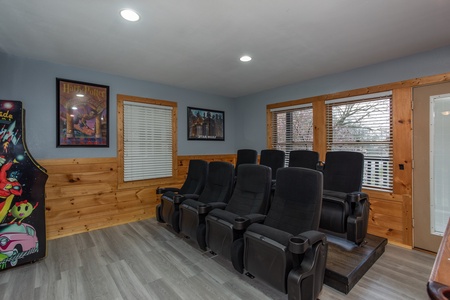 Theater room seats in the game room at Mountain Music, a 5 bedroom cabin rental located in Pigeon Forge