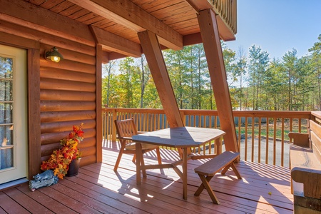 Picnic table on the deck at Living on Love, a 2 bedroom cabin rental located in Pigeon Forge