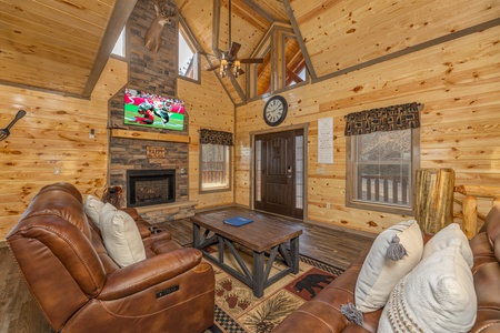 Living room with fireplace, TV, and seating at Everly's Splash, a 4 bedroom cabin rental located in Pigeon Forge