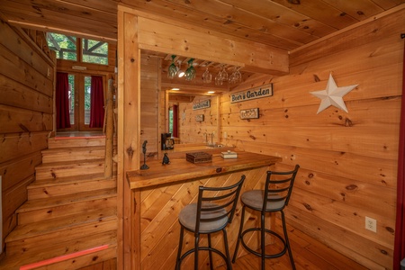Bar on the lower floor at Logan's Smoky Den, a 2 bedroom cabin rental located in Pigeon Forge