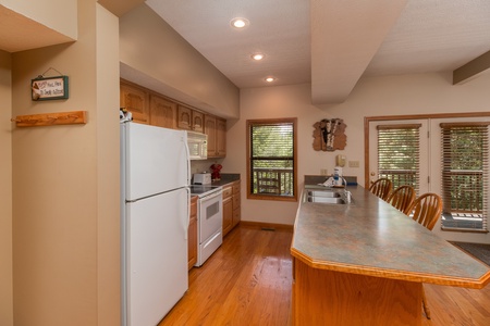 Kitchen with white appliances at Stones Throw, a 4 bedroom cabin rental located in Pigeon Forge