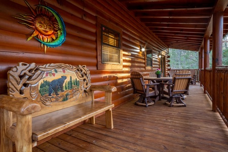 Bench and Table With Chairs Under Covered Deck at 3 Crazy Cubs, a 5 bedroom cabin rental located in pigeon forge