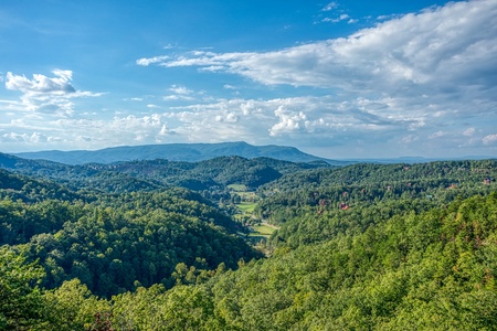 Views of the mountains surrounding a valley at Four Seasons Palace, a 5-bedroom cabin rental located in Pigeon Forge